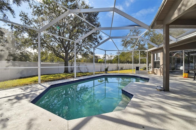 view of pool with a patio and glass enclosure