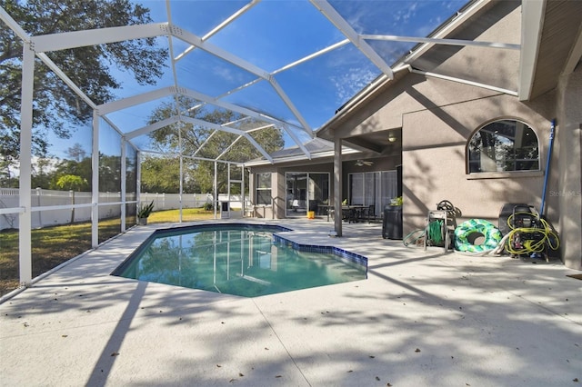 view of pool featuring glass enclosure and a patio area