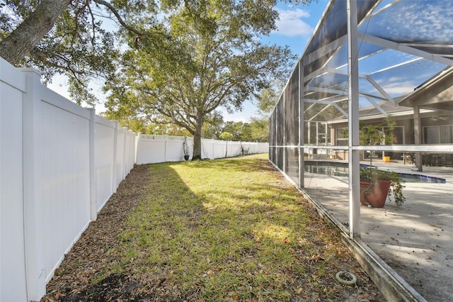 view of yard featuring a fenced in pool, a patio, and a lanai