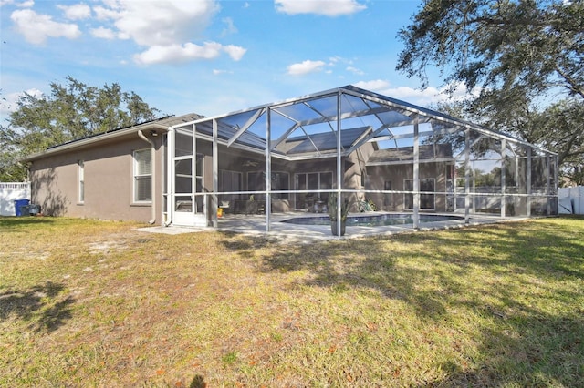 rear view of property featuring a swimming pool, a lawn, and a lanai