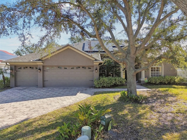 ranch-style home featuring a garage and a front yard