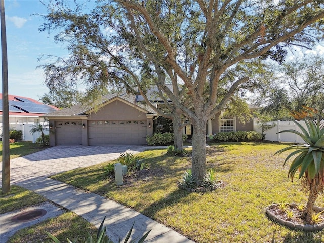 ranch-style home featuring a garage and a front yard