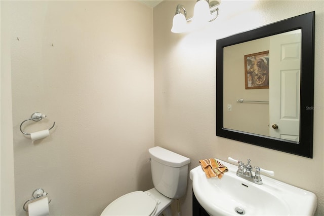 bathroom featuring toilet and sink