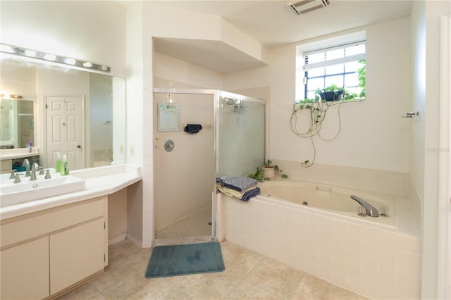 bathroom featuring tile patterned flooring, shower with separate bathtub, and vanity