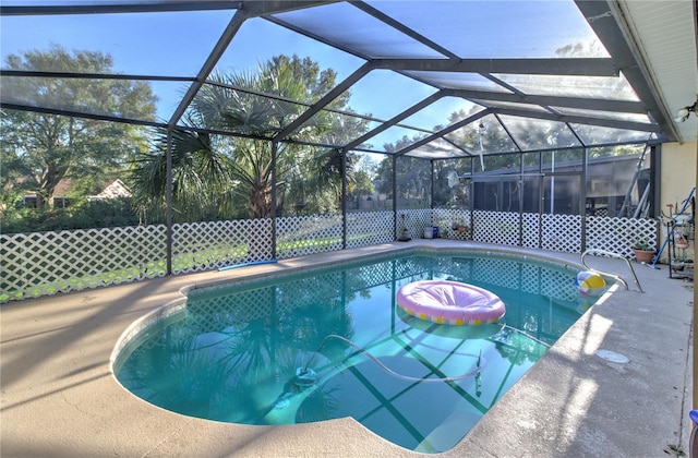 view of pool featuring a patio area and glass enclosure