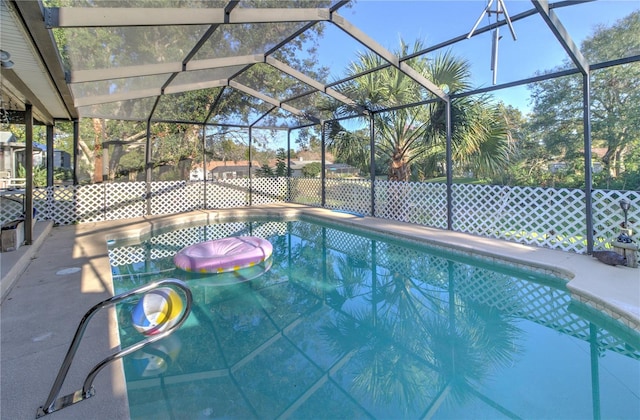 view of pool with glass enclosure