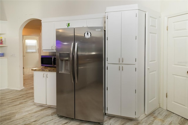 kitchen featuring white cabinetry, stainless steel appliances, and light wood-type flooring