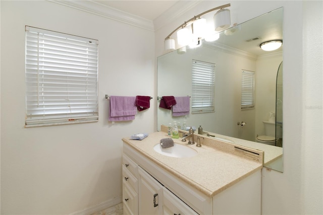 bathroom featuring crown molding, vanity, and toilet