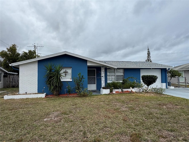 single story home with a garage and a front lawn