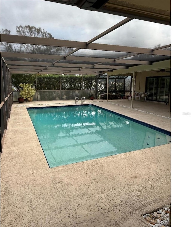 view of pool featuring a lanai and a patio