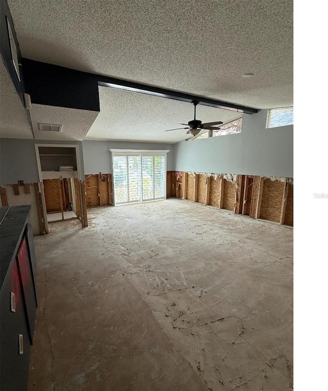 interior space featuring ceiling fan and a textured ceiling