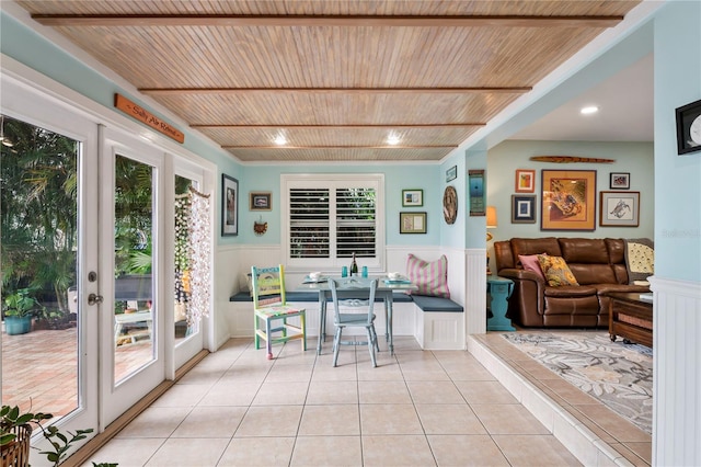 sunroom featuring breakfast area, french doors, and wood ceiling