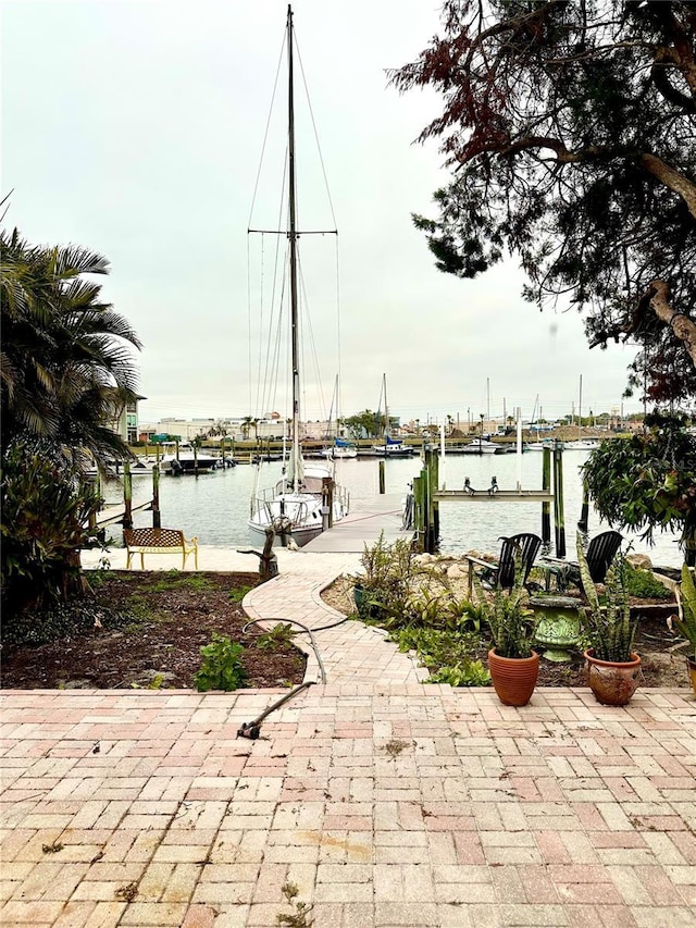 view of patio / terrace with a dock and a water view