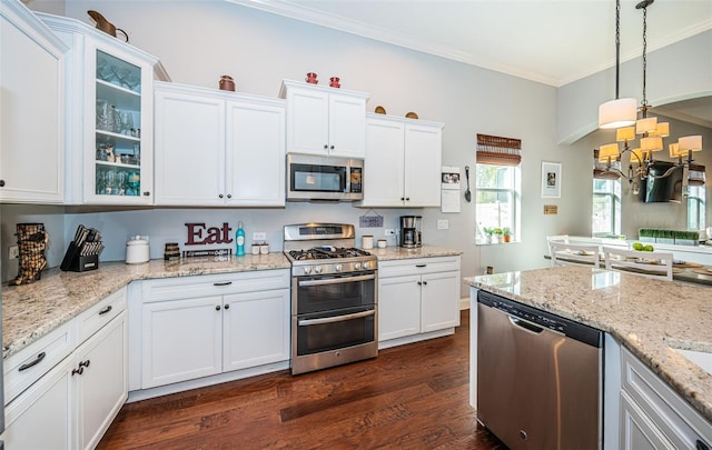 kitchen with white cabinetry, ornamental molding, stainless steel appliances, and dark hardwood / wood-style floors