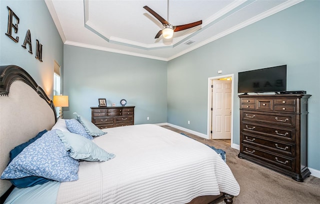 carpeted bedroom featuring crown molding, a tray ceiling, and ceiling fan