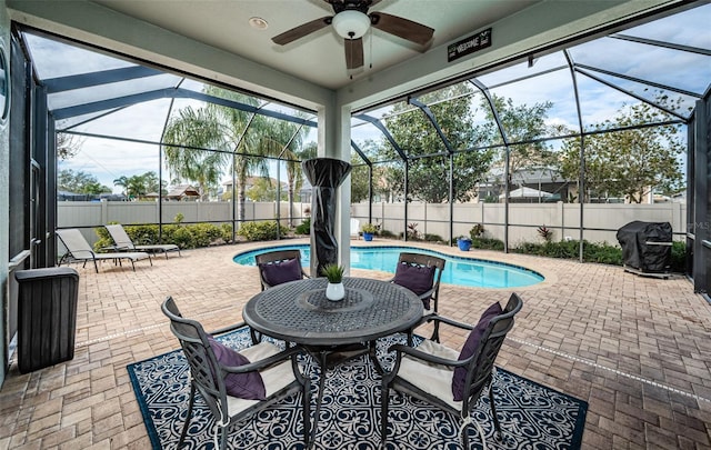 view of patio with ceiling fan, a fenced in pool, area for grilling, and glass enclosure