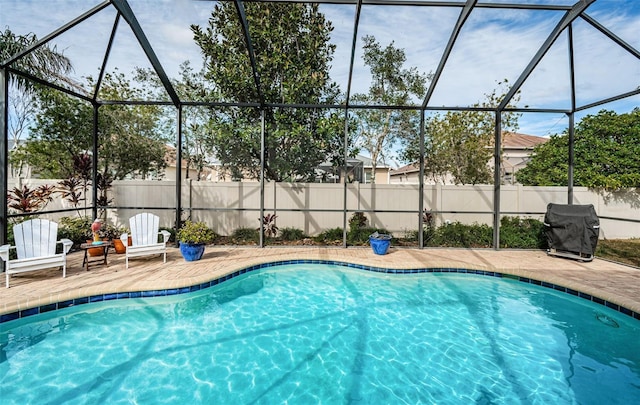 view of pool featuring area for grilling, a lanai, and a patio area