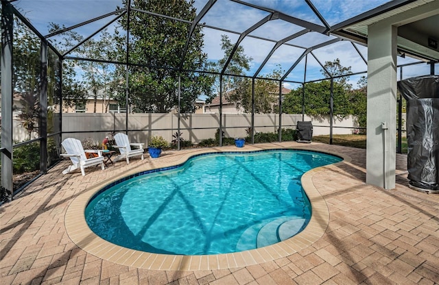 view of swimming pool with a patio and a lanai