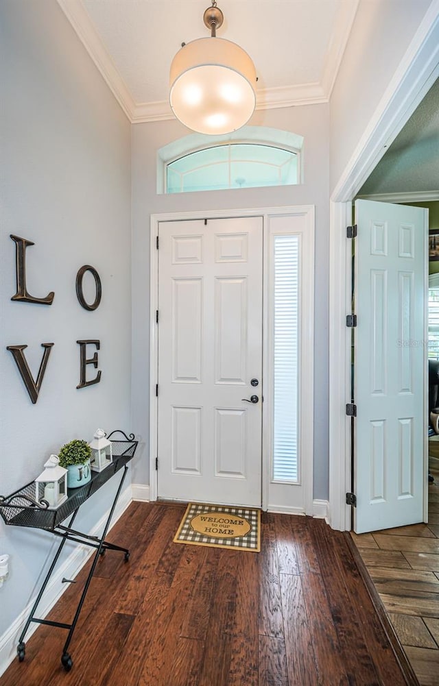 entryway featuring dark wood-type flooring and ornamental molding