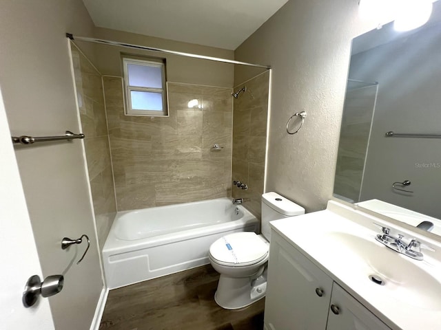 full bathroom featuring vanity, toilet, tiled shower / bath combo, and wood-type flooring