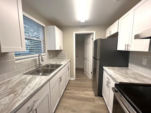 kitchen featuring sink, white cabinetry, and light wood-type flooring