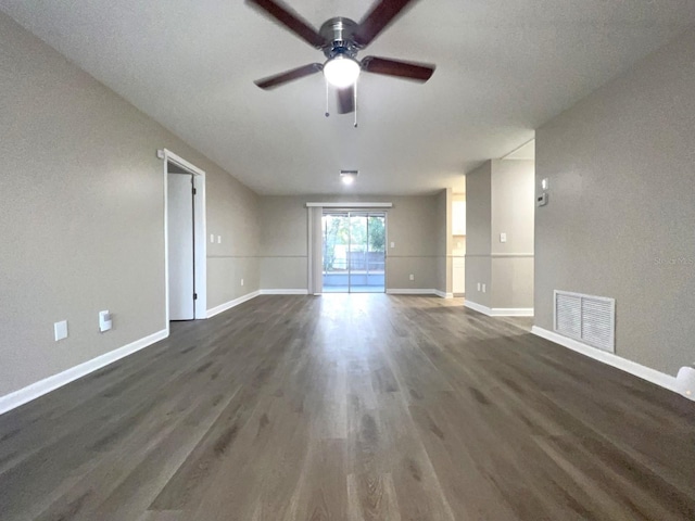 unfurnished living room featuring ceiling fan and dark wood-type flooring