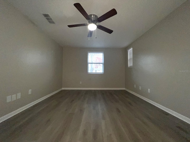 unfurnished room featuring ceiling fan and dark hardwood / wood-style flooring