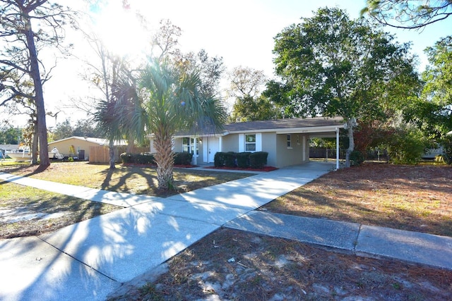 ranch-style house featuring a carport