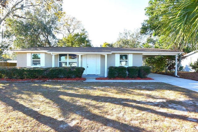 ranch-style home with a front yard and a carport