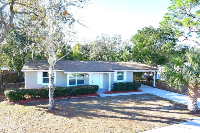 ranch-style house featuring a carport