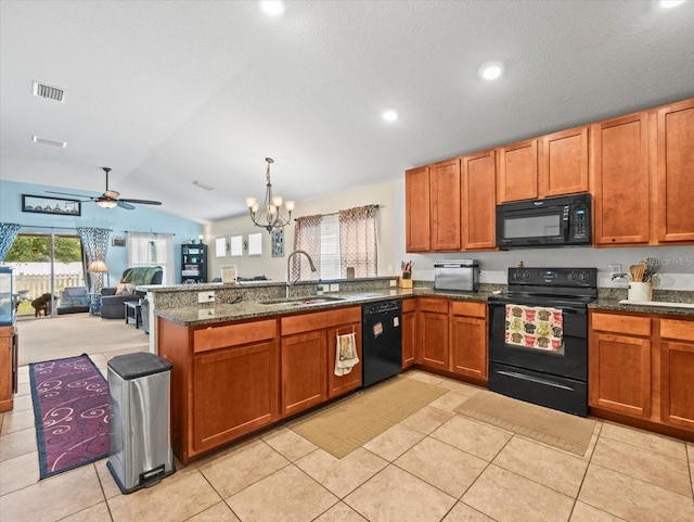 kitchen with black appliances, lofted ceiling, decorative light fixtures, sink, and light tile patterned floors