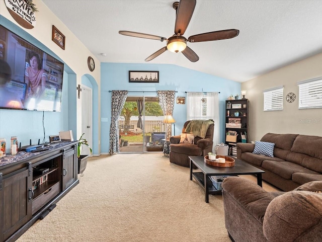 living room with ceiling fan, light colored carpet, and lofted ceiling