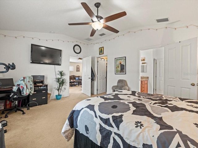 bedroom with ceiling fan, ensuite bathroom, lofted ceiling, and light carpet