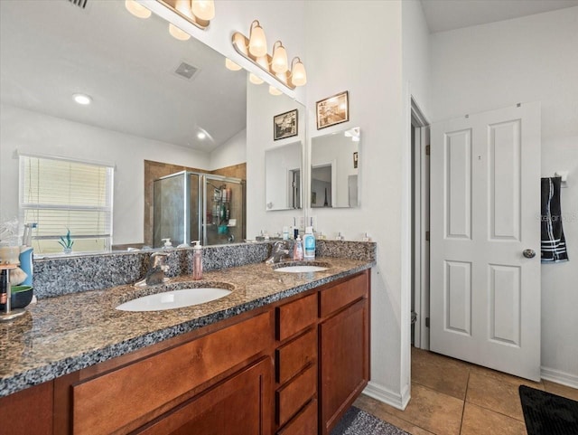 bathroom featuring vanity, a shower with door, and tile patterned flooring