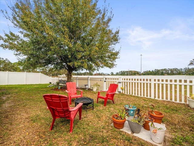 view of yard featuring an outdoor fire pit