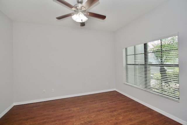 empty room featuring ceiling fan and dark hardwood / wood-style flooring