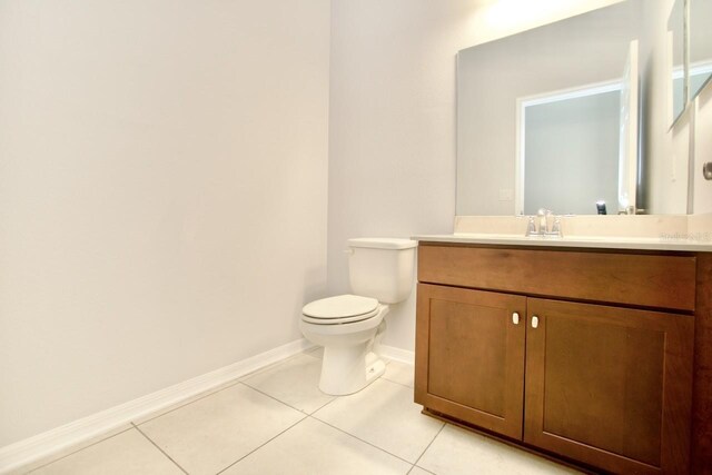 bathroom featuring toilet, tile patterned floors, and vanity