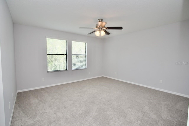 unfurnished room with ceiling fan and carpet flooring