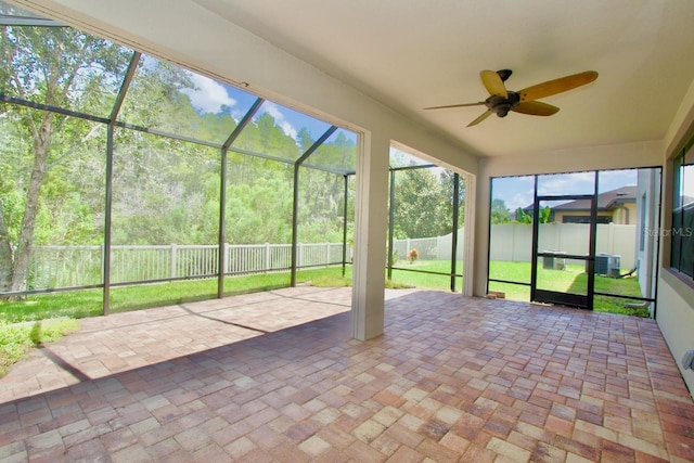 unfurnished sunroom featuring ceiling fan