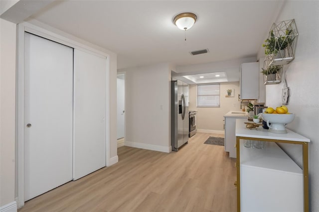 hall with sink and light hardwood / wood-style floors