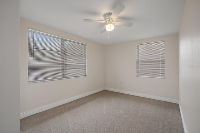 unfurnished room featuring ceiling fan and light colored carpet