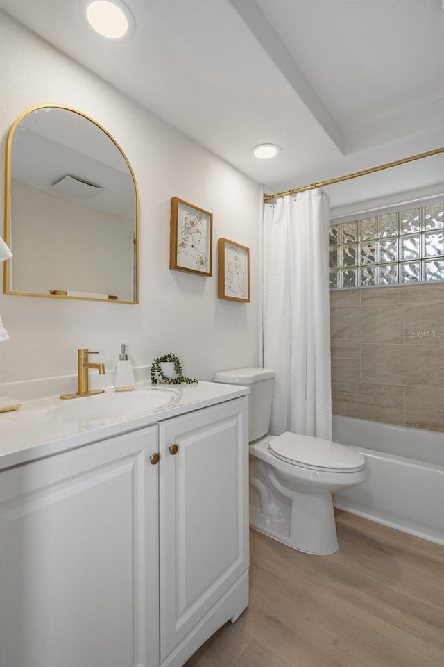 full bathroom featuring vanity, toilet, hardwood / wood-style floors, and shower / bath combo