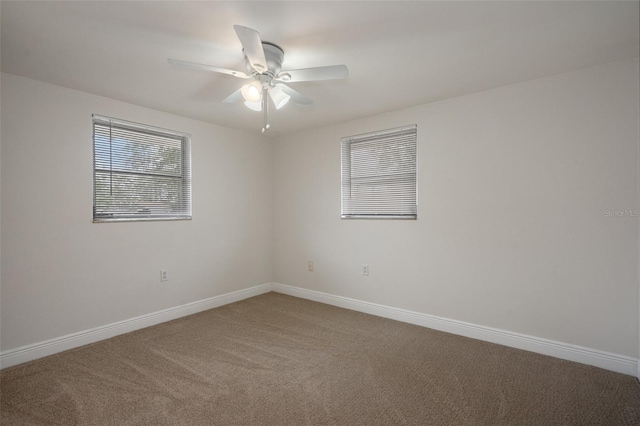 carpeted spare room with ceiling fan