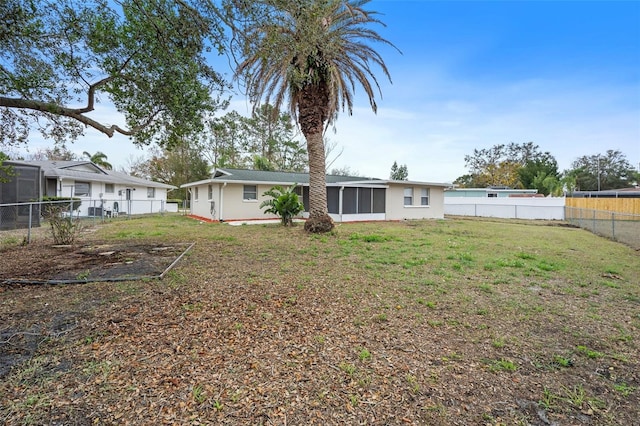 back of house with a lawn