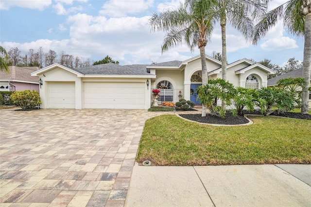 view of front of house with a front yard and a garage