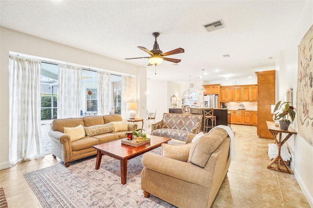 living room featuring ceiling fan and light tile patterned floors