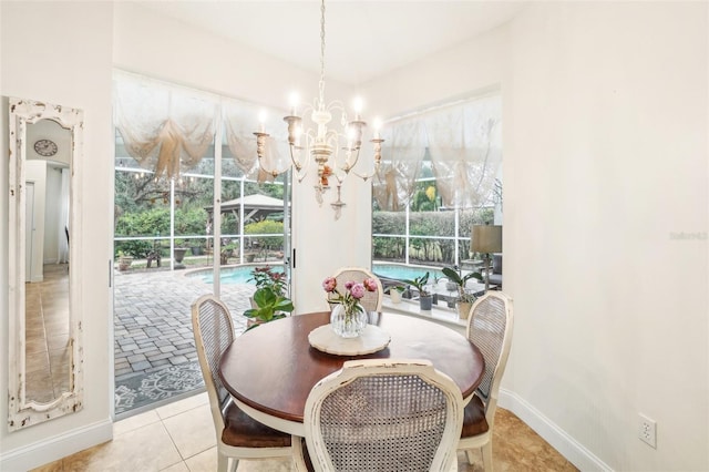 dining area featuring a chandelier and light tile patterned floors