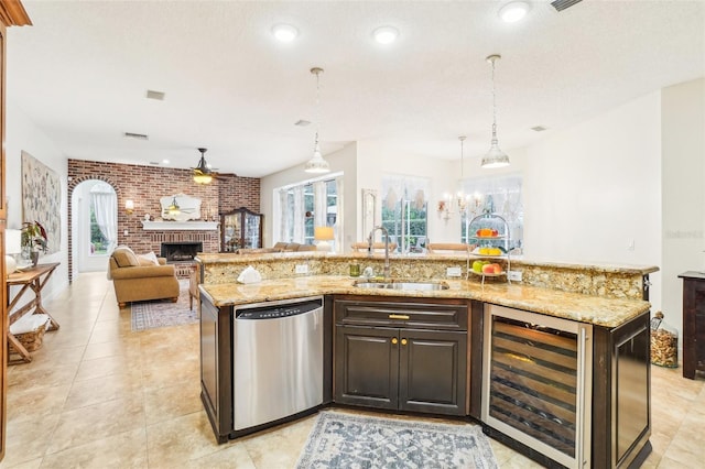 kitchen featuring sink, beverage cooler, dishwasher, and a kitchen island with sink