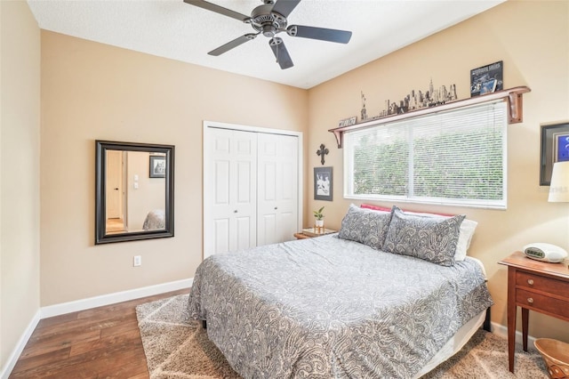 bedroom with ceiling fan, dark wood-type flooring, and a closet