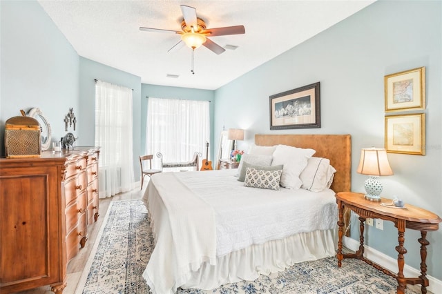 bedroom with ceiling fan and a textured ceiling